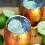 Moscow Mule Cocktail in copper mugs with sliced lime and ice