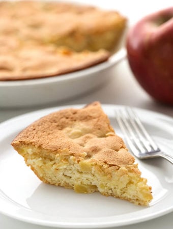 Slice of Norwegian Apple Pie on white plate with fork