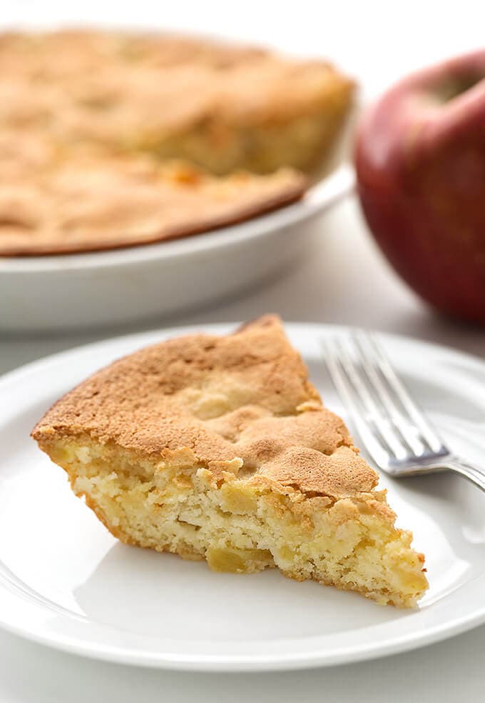 Slice of Norwegian Apple Pie on white plate with fork