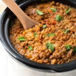 Crock Pot Curry Lentils in a crock pot with wooden serving spoon