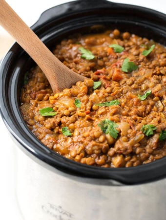 Crock Pot Curry Lentils in a crock pot with wooden serving spoon