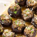 Several Easy Garlic Stuffed Mushrooms on a wooden board