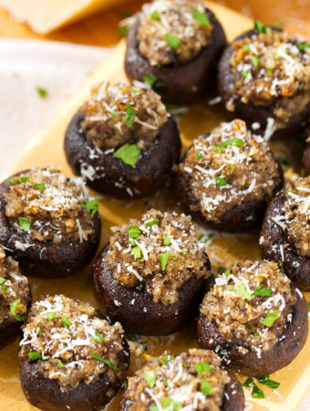 Several Easy Garlic Stuffed Mushrooms on a wooden board