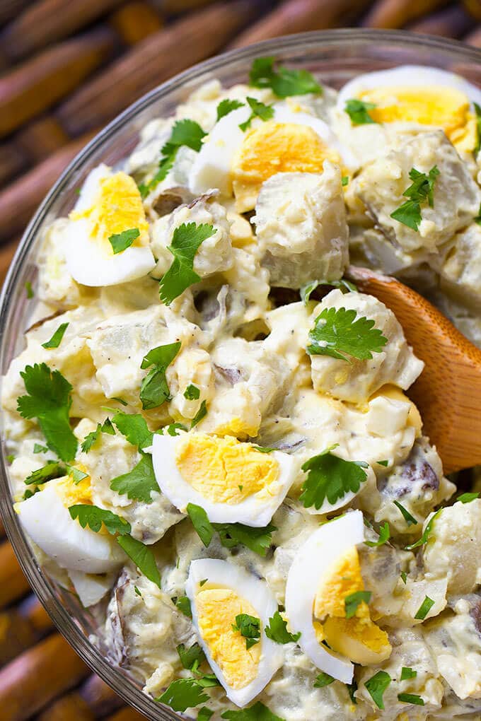 Close up of Easy Instant Pot Potato Salad with wooden spoon in glass bowl