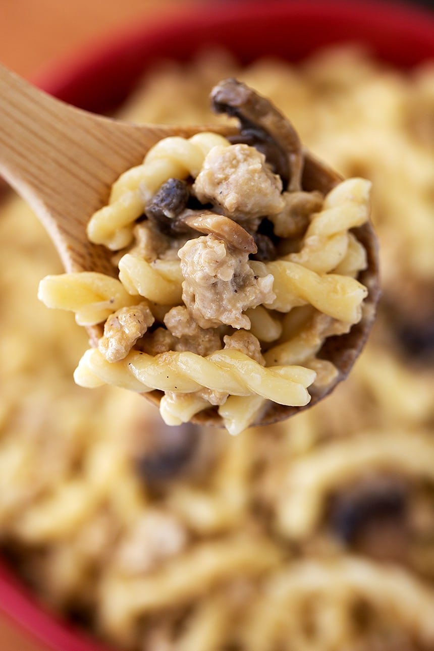 Close up of Instant Pot Cheeseburger Pasta on wooden serving spoon