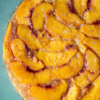 Peach Upside Down Cake on a turquoise serving platter