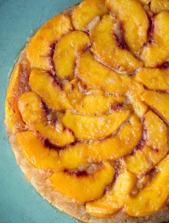 Peach Upside Down Cake on a turquoise serving platter