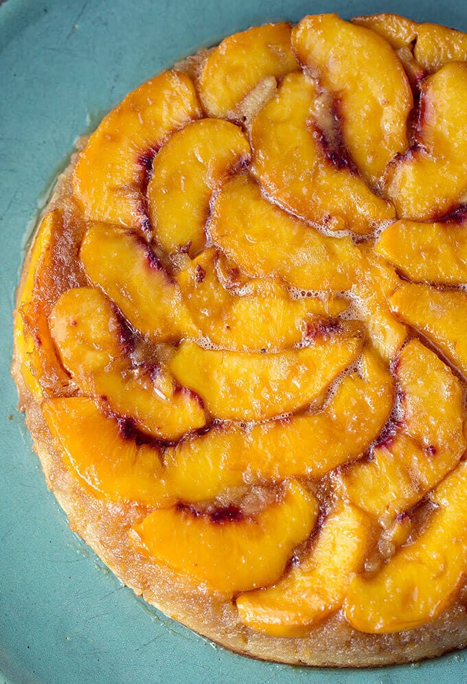 Peach Upside Down Cake on a turquoise serving platter