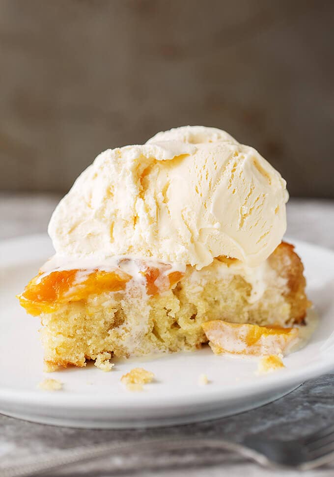 Peach Upside Down Cake slice with ice cream on top.