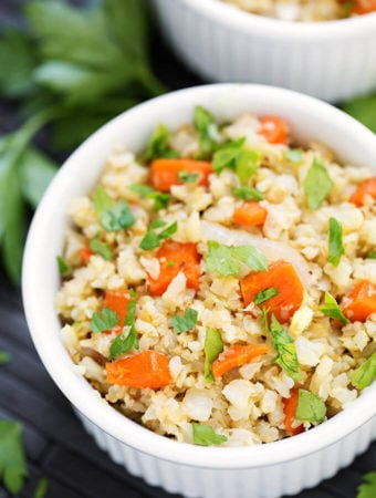 Roasted Cauliflower Rice with Carrots in a small white bowl