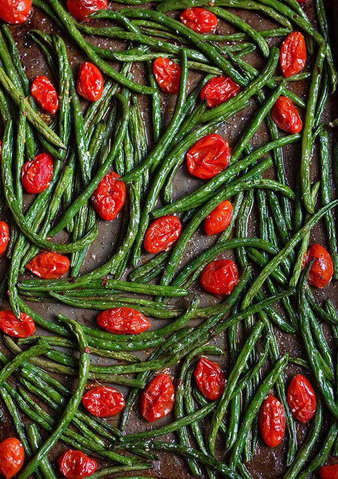 Roasted Spicy Green Beans with Tomatoes on a baking sheet