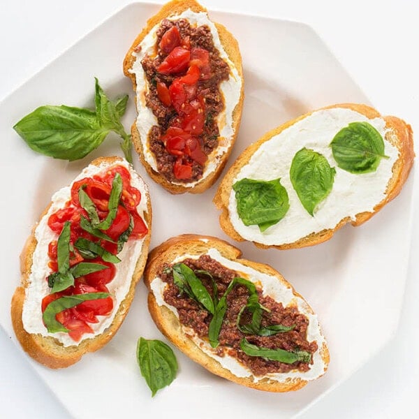Four Bruschetta on a white plate