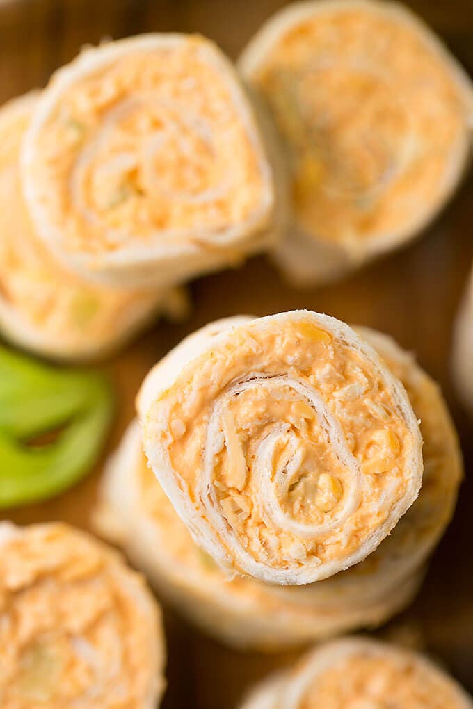 Close up of Buffalo Chicken Pinwheels on wooden board