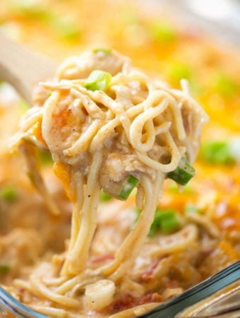 Creamy and Cheesy Baked Chicken Spaghetti on wooden serving spoon