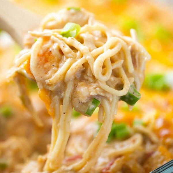 Creamy and Cheesy Baked Chicken Spaghetti on wooden serving spoon