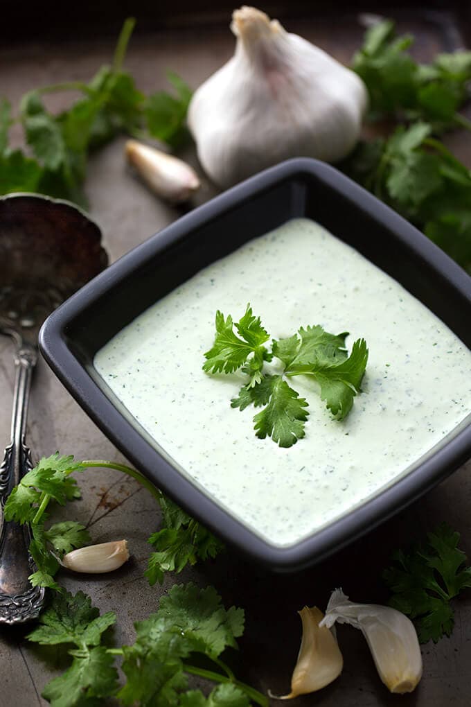 Creamy Cilantro Dressing in square black serving dish garnished with cilantro