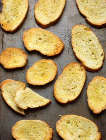 Several Crostini on metal baking sheet