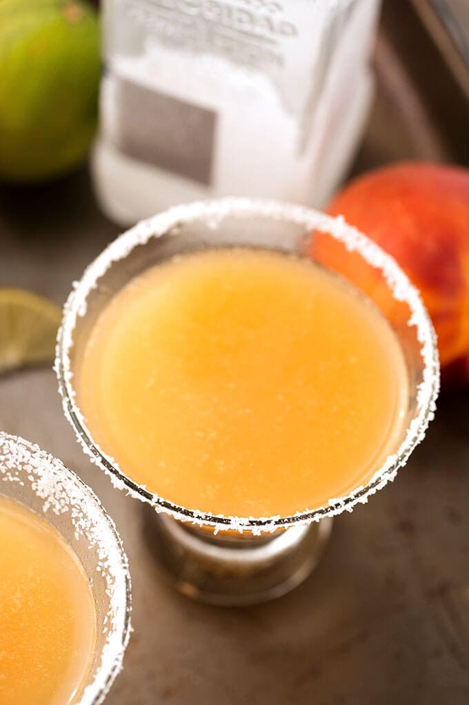 Fancy Peach Margarita in a small glass with salt on the rim 