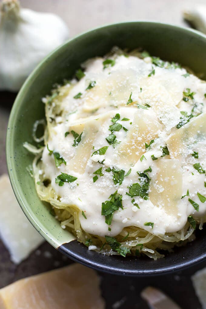 Garlic Parmesan Cream Sauce topping spaghetti squash in green and blue bowl