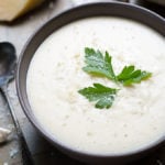 Garlic Parmesan Cream Sauce in a black bowl garnished with parsley