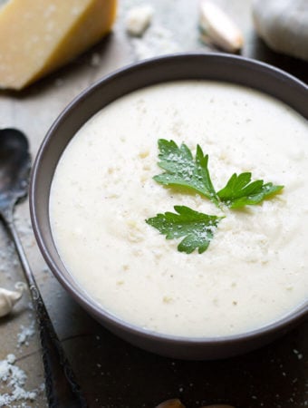 Garlic Parmesan Cream Sauce in a black bowl garnished with parsley