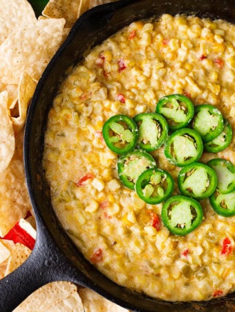 Hot Cheesy Corn Dip is a flavorful game day and party favorite. With corn, green chilis and cheese, we love this dip. simplyhappyfoodie.com #corndip #gameday #appetizer