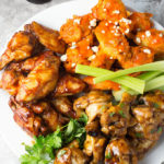 Three types of pressure cooker wings on white plate with celery