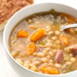 Instant Pot Ham Hock and Bean Soup in a white bowl with spoon