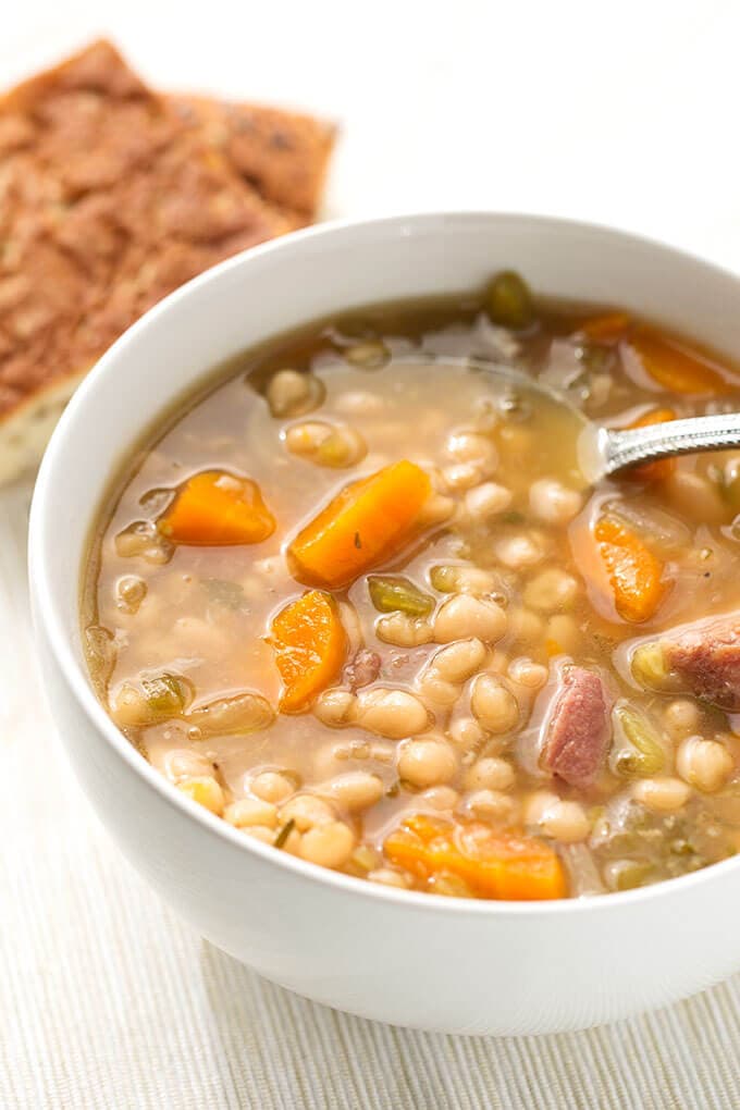 Ham Hock and Bean Soup and a silver spoon in a white bowl