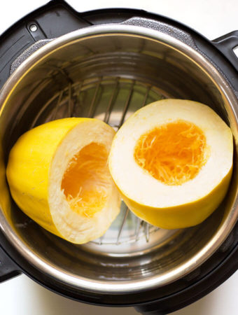 Instant Pot Spaghetti Squash cut in half on trivet in pressure cooker