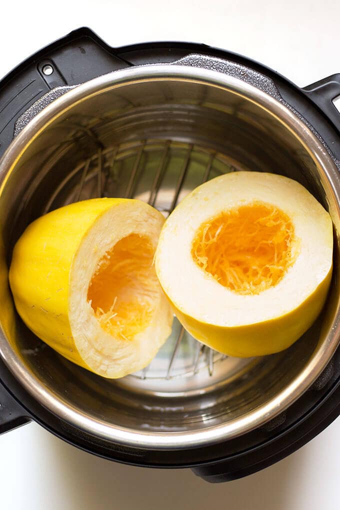 Instant Pot Spaghetti Squash cut in half on trivet in pressure cooker