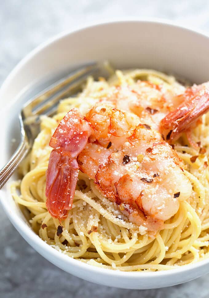 Close up of Lemony Capellini with Shrimp with a fork in a white bowl