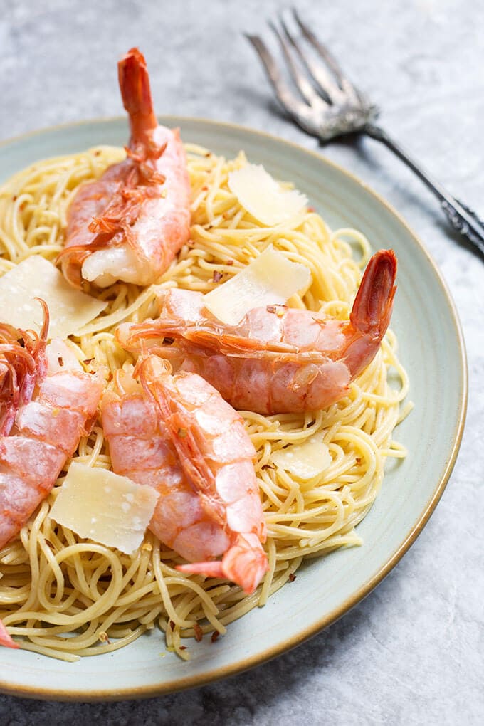 Lemony Capellini with Shrimp on a white plate with fork in the background