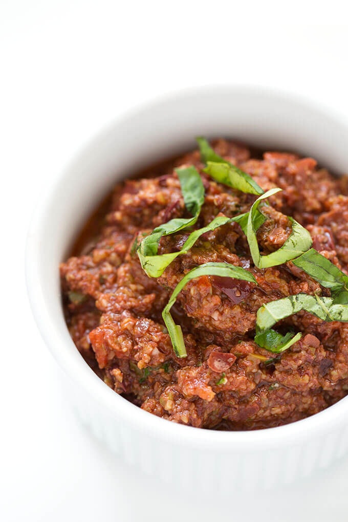 Olive Tapenade in small white bowl on white background
