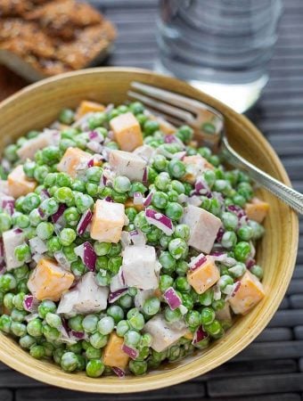 Pea Salad with Smoked Turkey in a dark yellow bowl with fork