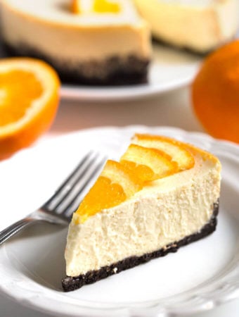 Slice of Pressure Cooker Dreamy Orange Cheesecake on a white plate with fork