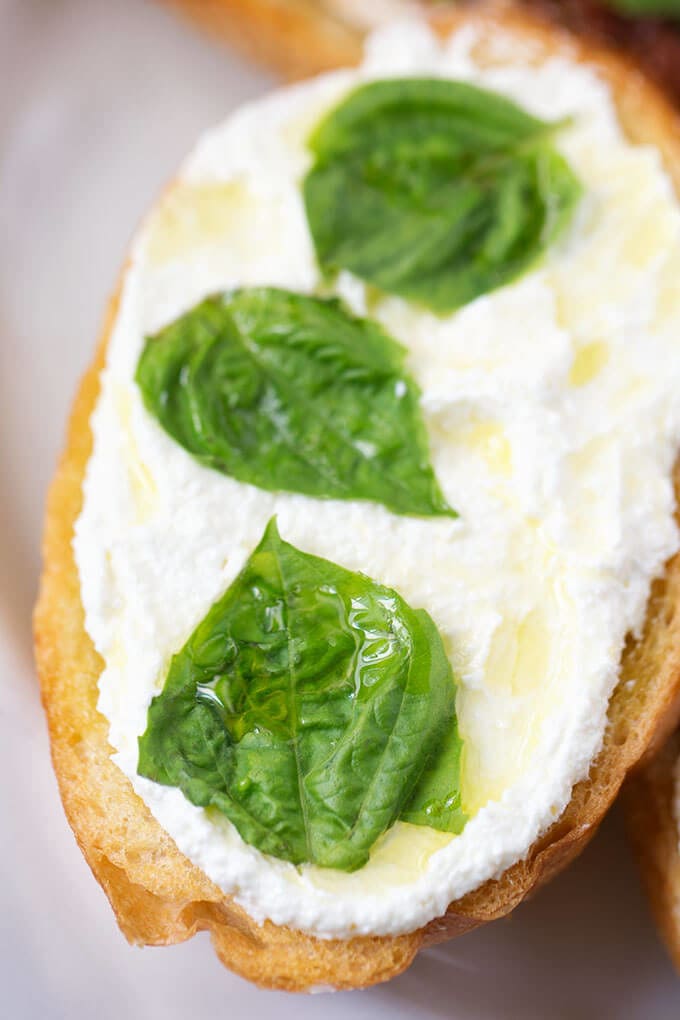 Whipped Feta Spread on toasted bread garnished with basil leaves