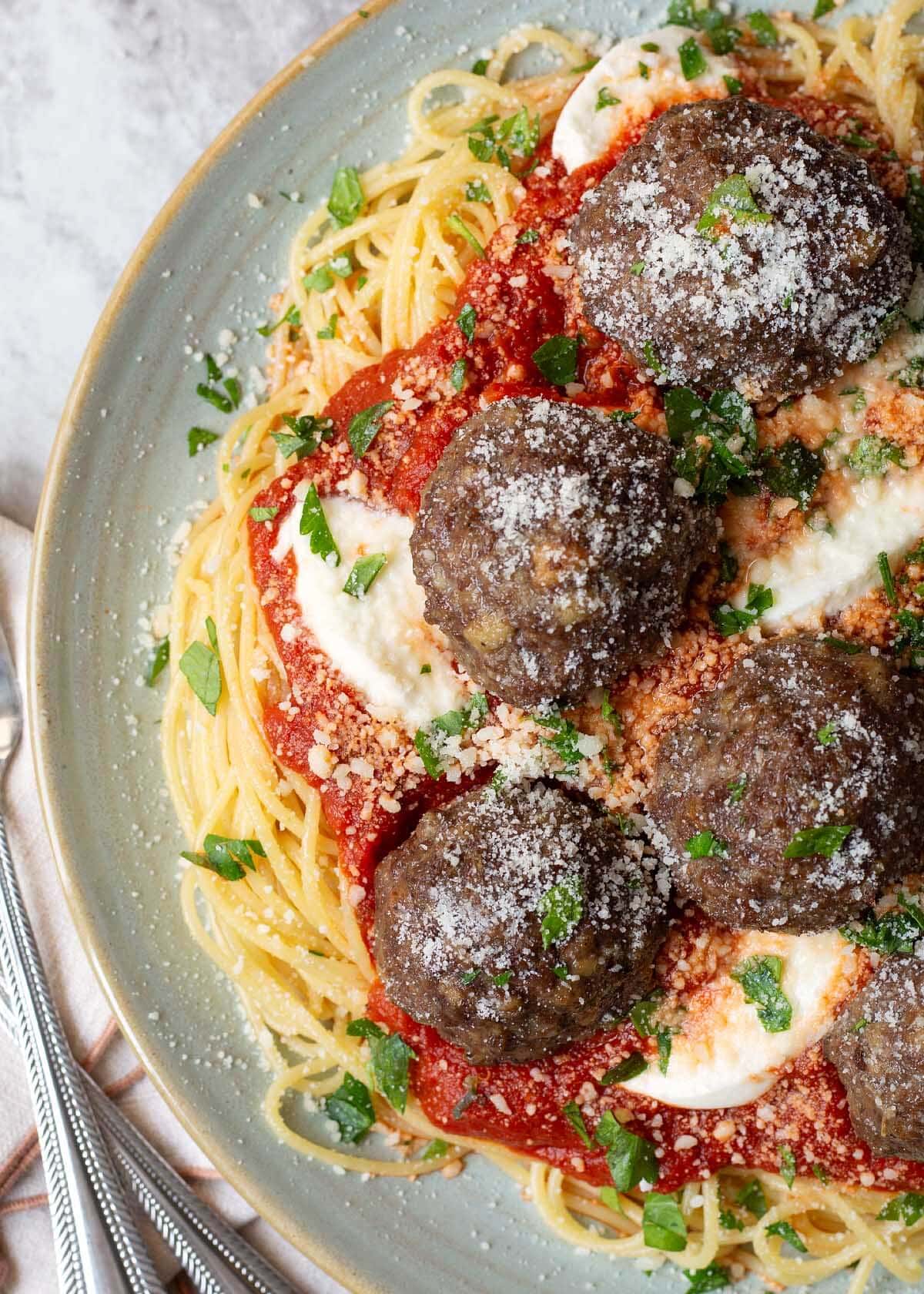 Meatballs on a plate of spaghetti.