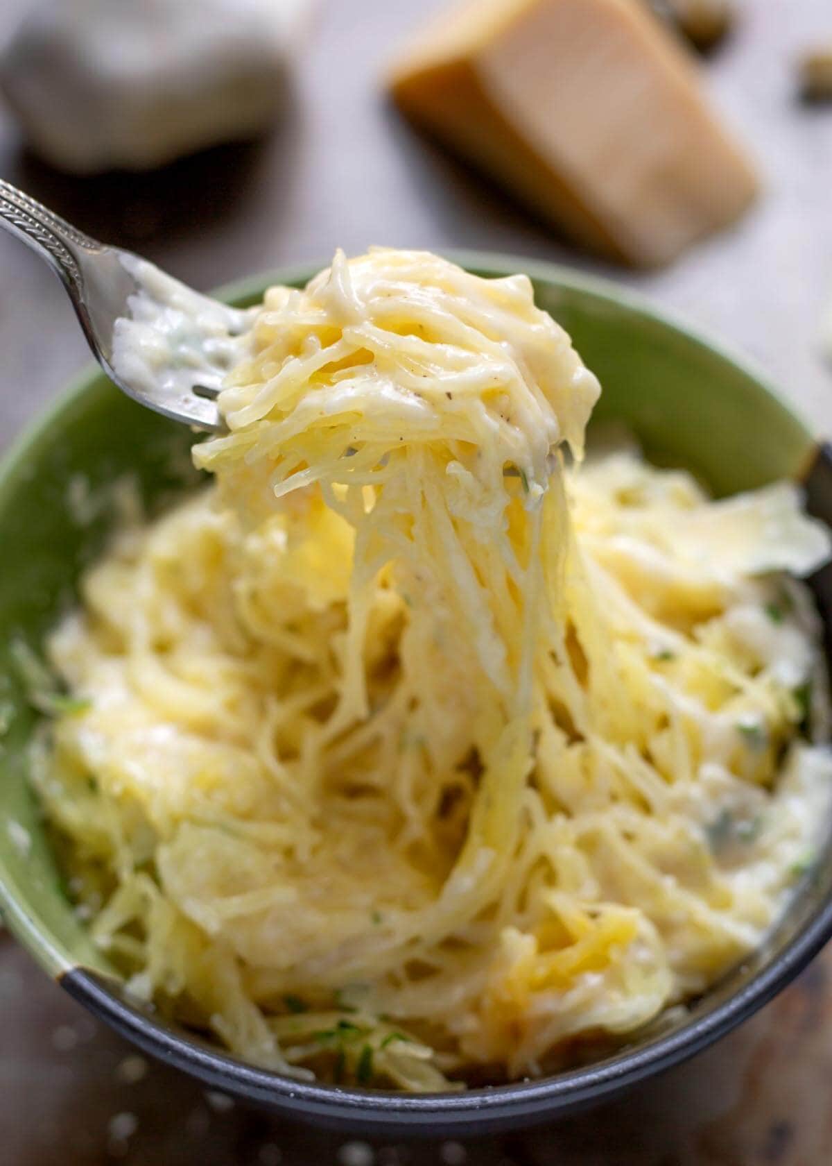 Garlic Parmesan Sauce on spaghetti squash on a fork.