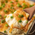 Cheesy Baked Orzo Pasta in dish and on spoon.