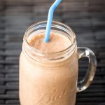 Chocolate Peanut Butter Banana Smoothie in glass Ball jar with blue straw