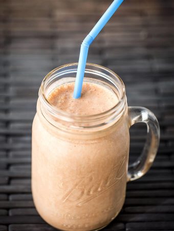 Chocolate Peanut Butter Banana Smoothie in glass Ball jar with blue straw