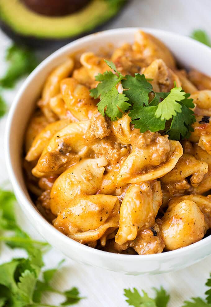 Cheesy Taco Pasta in white bowl garnished with cilantro