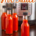 Instant Pot Hot Sauce in glass jars in front of IP