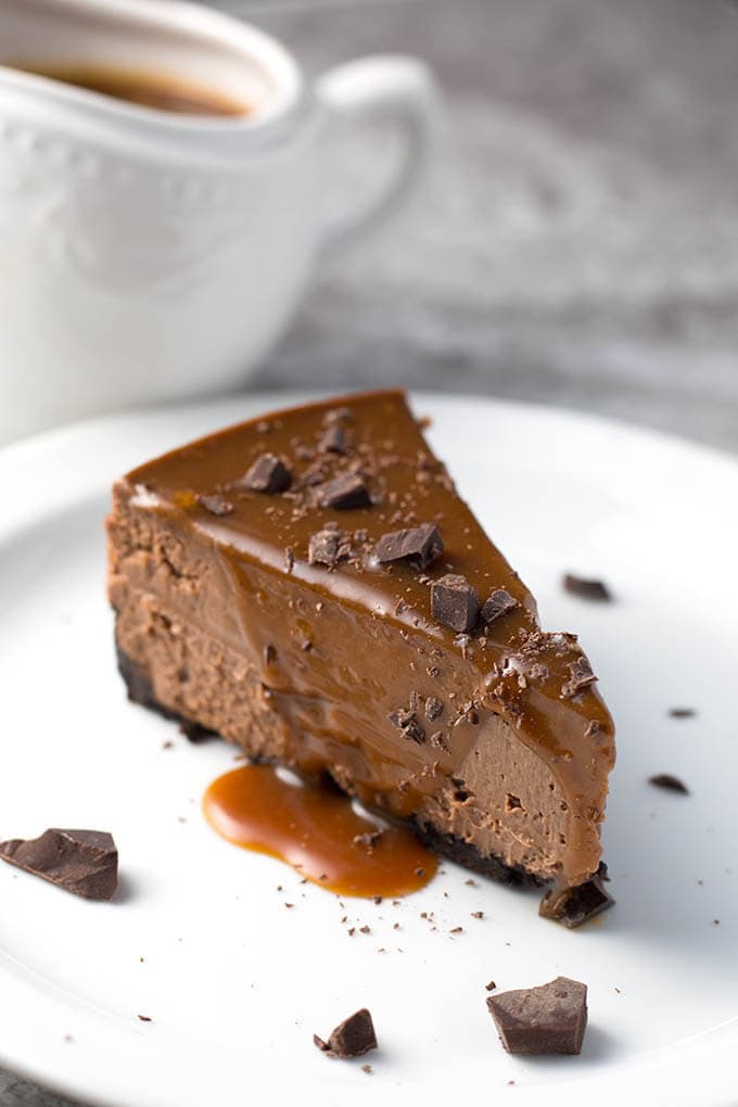 Slice of chocolate cheesecake on a white plate