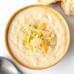 Creamy Cauliflower Soup in brown bowl from above.