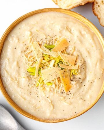 Creamy Cauliflower Soup in brown bowl from above.