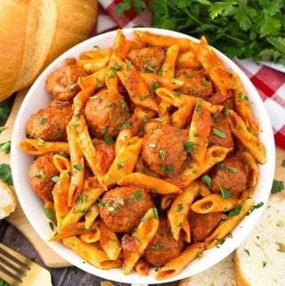 Instant Pot Meatball Pasta Dinner is a hearty pasta meal made with frozen pre-cooked meatballs. This pressure cooker meatball pasta is an easy weeknight meal in under an hour! simplyhappyfoodie.com #instantpotmeatballspasta #pressurecookermeatballpasta