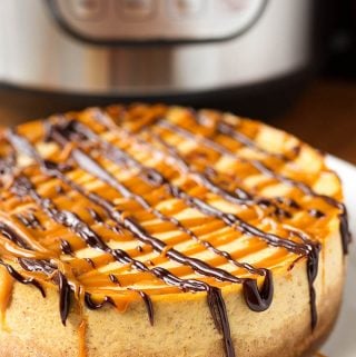 Instant Pot Pumpkin Cheesecake is creamy, and has just the right amount of pumpkin flavor. Accented with a little pumpkin spice, this is a tasty and well balanced cheesecake! simplyhappyfoodie.com #pumpkinrecipes #instantpotrecipes #instantpotcheesecake #instantpotpumpkincheesecake