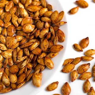 Roasted Pumpkin Seeds are a tasty and healthy snack. We enjoy them with different flavors, and this method works with all squash seeds. Roasted squash seeds are such a great treat! simplyhappyfoodie.com #roastedpumpkinseeds #pumpkinseeds How to roast pumpkin seeds, how to roast squash seeds